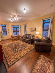 a living room with couches and a table at Goldfinch Suites in Elkader