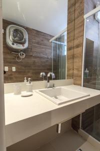 a bathroom with a sink and a mirror at Studio Oceanview in Rio de Janeiro