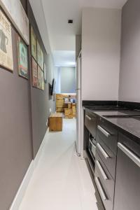a kitchen with a refrigerator and a white floor at Studio Oceanview in Rio de Janeiro