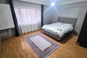 a bedroom with a bed and a large window at Sisli Apartments in Istanbul