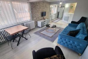 a living room with a blue couch and a table at Sisli Apartments in Istanbul