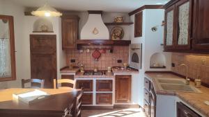 a kitchen with wooden cabinets and a counter top at Casa Baggino in Pistoia