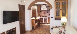 a kitchen with an archway leading into a living room at Casa Baggino in Pistoia