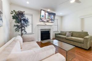 a living room with two couches and a fireplace at Amazing Location Spacious House in Atlanta