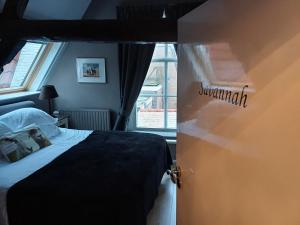 um quarto com uma cama e uma janela em B&B De zilveren reiger em Middelburg