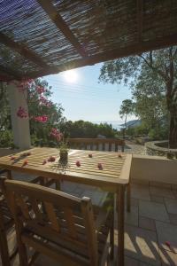 a wooden table and chairs on a patio at Nereidi Villas in Porto Ozias