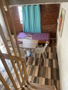 a room with a table and a purple couch at Cab, SE ,1 in Villa Los Aromos