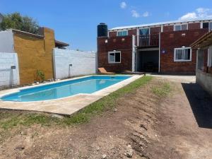 a swimming pool in front of a building at Cab, SE ,1 in Villa Los Aromos