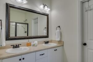 a bathroom with two sinks and a large mirror at Our Corner Cottage in Aiken +12 photos