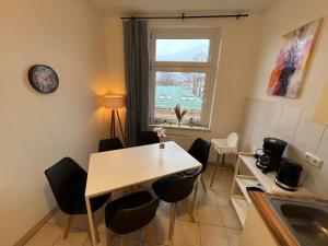 a kitchen with a table and chairs and a window at Blue Chili 00 - Moderne Familienwohnung, Top Lage in Magdeburg +15 photos