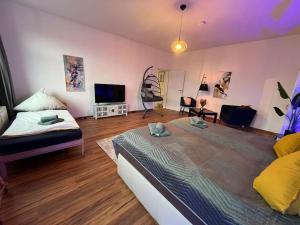 a bedroom with a large bed and a television at Blue Chili 00 - Moderne Familienwohnung, Top Lage in Magdeburg