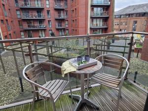 a table and two chairs on a balcony at Luxury Modern Apartment Stay in Sheffield