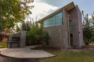a house with a large window on the side of it at Alamos de Perdriel in Perdriel