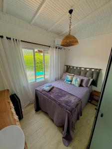 Ένα ή περισσότερα κρεβάτια σε δωμάτιο στο Pousada Orquídeas do Guarujá +120 φωτογραφίες