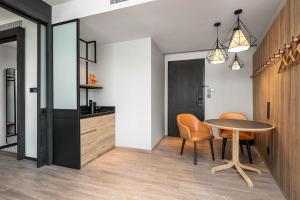 a kitchen and dining room with a table and chairs at Moxy Bangkok Ratchaprasong in Bangkok