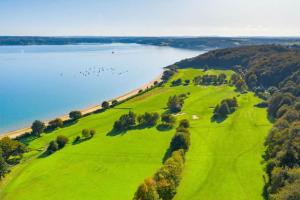 an aerial view of a golf course next to the water at Golf et sentiers côtiers in Carantec