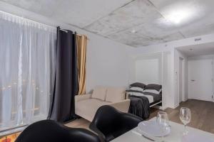 a living room with a bed and a table and chairs at Furnished Studio with balcony - Downtown #311784 in Montreal