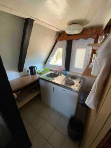 a small kitchen with a sink and a stove at Finnhütte Oase in Berlin