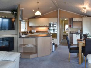 a kitchen and living room of a caravan at Sunset Lodge in Llanddulas
