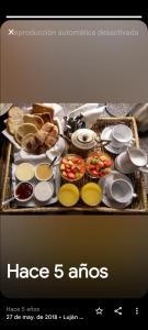 a tray of food with bread and other foods on it at Alonso Chacras Lodge in Chacras de Coria