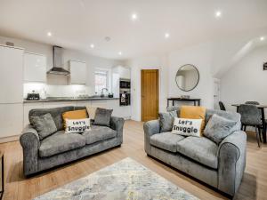 a living room with two couches and a kitchen at Salix 3 - Uk46115 in Wigginton