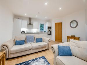 a living room with two couches and a kitchen at Salix 4 - Uk46116 in Wigginton