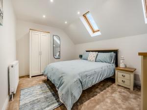 a bedroom with a bed and a dresser and mirror at Salix 3 - Uk46115 in Wigginton