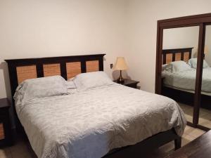 a bedroom with a large bed and a mirror at Sonoran Sky Resort Vista a Playa Azul in Puerto Peñasco