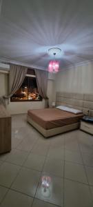 a bedroom with a bed and a large window at perle du tanger in Tangier