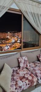 a couch in front of a window with a view at perle du tanger in Tangier