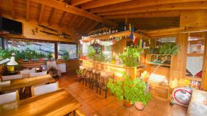 a restaurant with a bar with tables and chairs at Xalet Refugi Pere Carné in La Molina