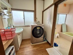 a bathroom with a tv in the corner of a room at Snow Fever - Clan in Hakuba