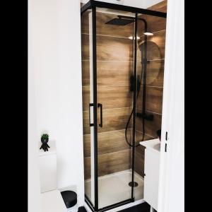 a shower with a glass door in a bathroom at Studio EASY CHECK-IN 8 mins Disneyland 35 mins Paris FREE Starbucks coffee parking wifi in Bussy-Saint-Georges