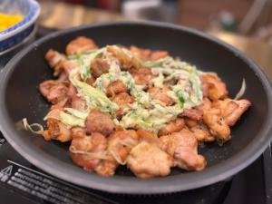 a bowl of food with broccoli and other foods at Hotel Alps in Osaka