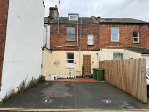 an empty parking lot in front of a house at Comfortable Modern Home, Self Catering Flat, Newly refurbished, town centre, free parking in Cheltenham