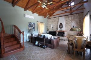 a living room with a bed and a staircase at Elite Escape in Tsoukalades