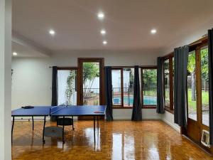 una mesa de ping pong azul en una habitación con ventanas en luxury 5 bedrooms, Pool, Quiet, en Melbourne