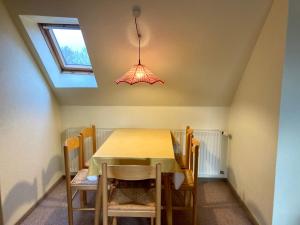 a dining room with a table and chairs and a light at Nordsee 403 in Wangerooge