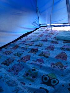 a bed with a bedspread with skulls on it at Camping beira mar in Bertioga
