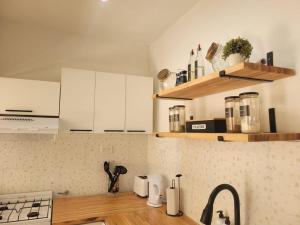 a kitchen with white cabinets and a counter top at Sueño Maipú in Mar del Plata