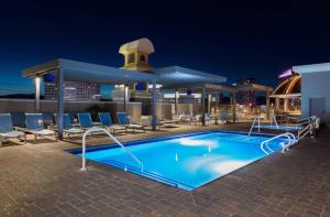 a pool on the rooftop of a hotel at night at Marriott's Grand Chateau in Las Vegas