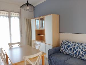 a living room with a table and a couch at Ariston Vacanze in Marina di Ravenna