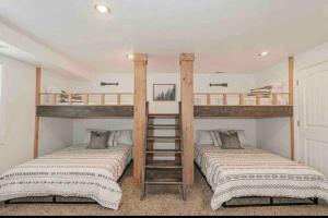 two beds in a room with two bunk beds at Wilson Family Retreat in Blackfoot