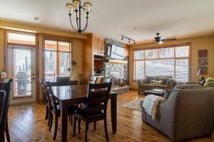 a living room with a table and chairs and a couch at The Aspens 5 w/ Hot Tub in Big White