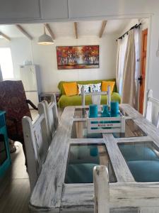 a living room with a wooden table and a couch at ALOJAMIENTO AVENIDA DEL MAR CABAÑA LA SERENA in La Serena +7 photos