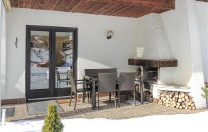 a patio with a table and chairs and a fireplace at Cozy Home In Tannheim With Wifi in Tannheim