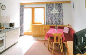 a kitchen with a table and a dining room at Cozy Apartment In Kappl With House A Mountain View in Kappl