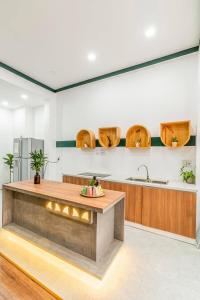 a kitchen with a counter and a sink at Laé Hostel in Tuy Hoa