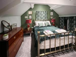 een slaapkamer met een bed en een groene muur bij The Stables - Uk44766 in Ripon