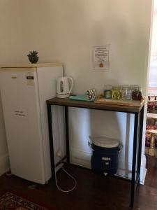 a table next to a refrigerator next to a counter at Yealering Hotel in Yealering